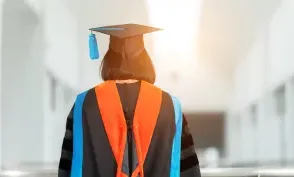 PhD student with their back facing viewer wearing an orange nursing hood